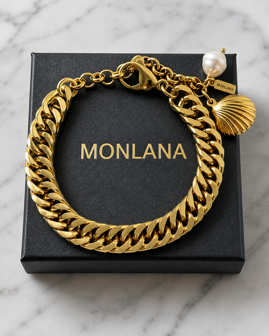 Close-up of MONLANA gold Cuban bracelet with shell charm and pearl