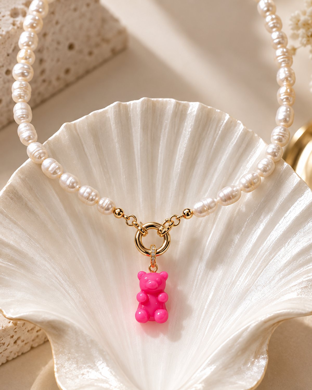 MONLANA Natural Pearl Necklace with Pink Gummy Bear pendant displayed on a shell